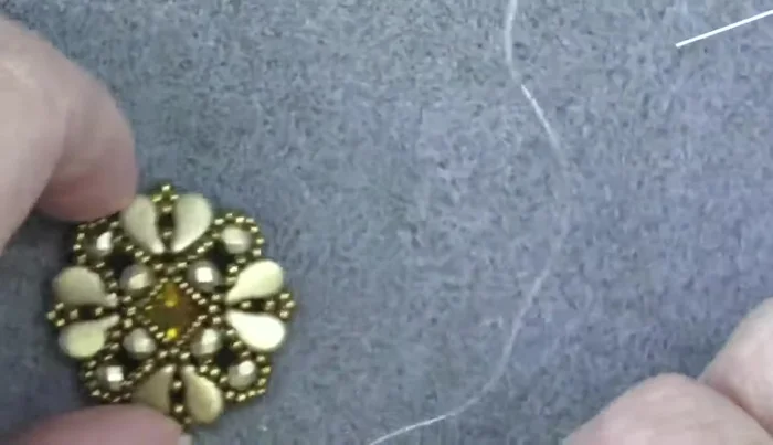 Attach the filigree backing using glue.