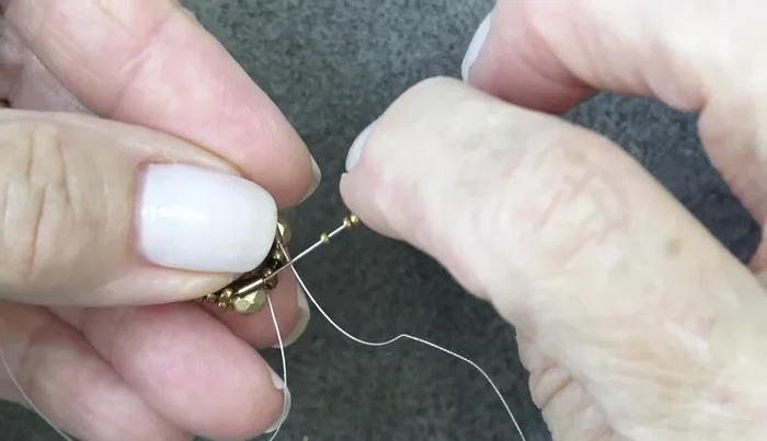 Add two 15/0 seed beads, exiting three 15/0s and sewing through the next three. Repeat two more times.