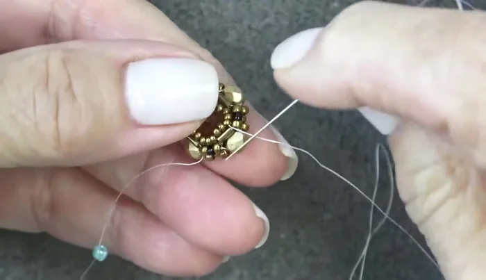 Add a final round of 11/0 seed beads to complete the bezel. Shape and adjust as needed.