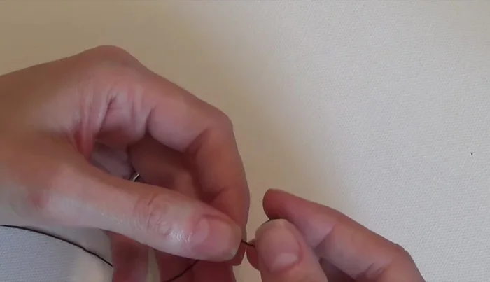 Add three 12mm beads and tie a single knot.