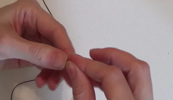 Repeat step 3, adding beads and knots. The sequence is: one spacer bead, one 12mm bead, one spacer bead, knot; three 12mm beads, spacer bead, three 12mm beads, knot; spacer bead, 12mm bead, spacer bead, knot; three 12mm beads, double knot.