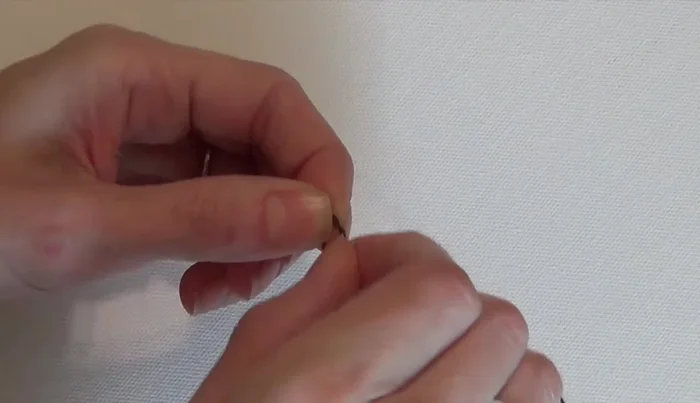 Add three 12mm beads and tie a single knot.