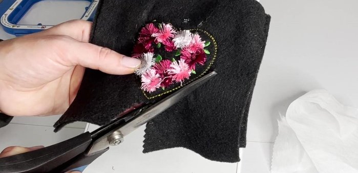 Unhoop, tear away stabilizer, and trim 0.25 inches from the stitch border.