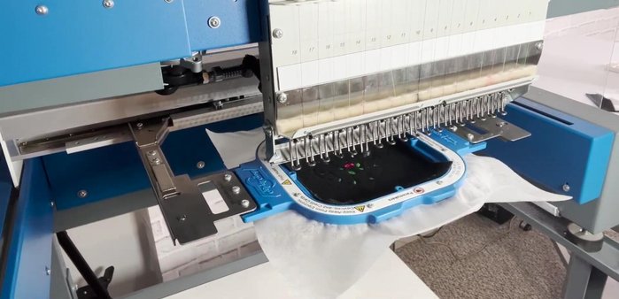 Embroider your fringe flower design using a machine. Stop as soon as the fringe flowers are complete to preserve the stitch border.