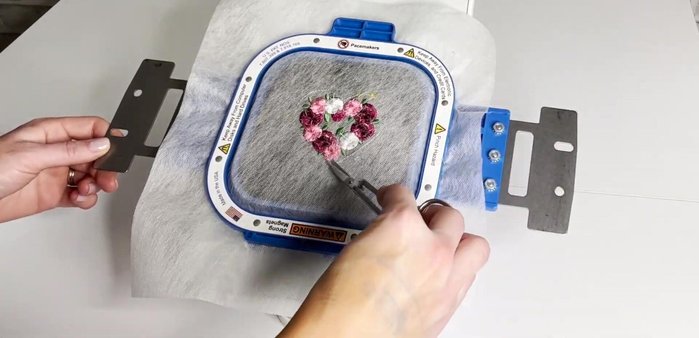 Carefully clip the embroidery thread on the back of the flowers for the fringe effect. Cutting only the bobbin thread creates loops; cutting along the outer edge will fray.