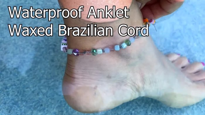 Prepare the cord: Thread the waxed cord onto a plastic star button and tie an overhand knot, cutting the ends at an angle for easier bead threading.