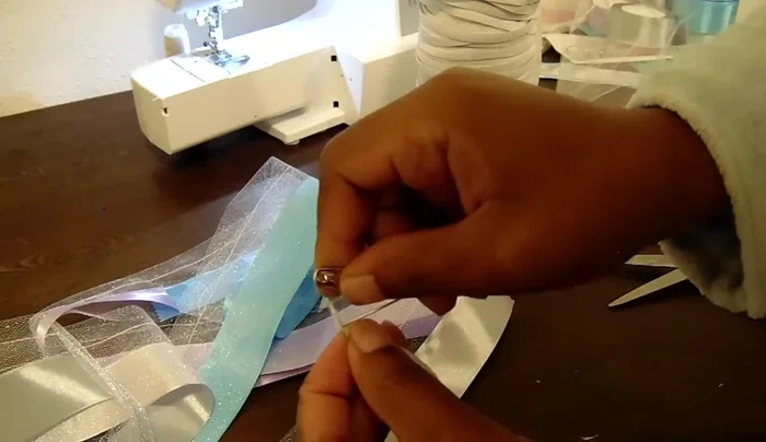 Insert elastic: Insert a safety pin into one end of a 7.5-inch piece of 1/4-inch knit elastic (adjust length as needed for age), and thread it through the tulle casing. Secure the other end with a clothing pin to prevent it from going all the way through.