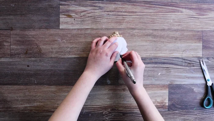 Apply the transfer to the brooch using an applicator tool, ensuring proper alignment. Seal with a water-based sealer, avoiding the gold paint.